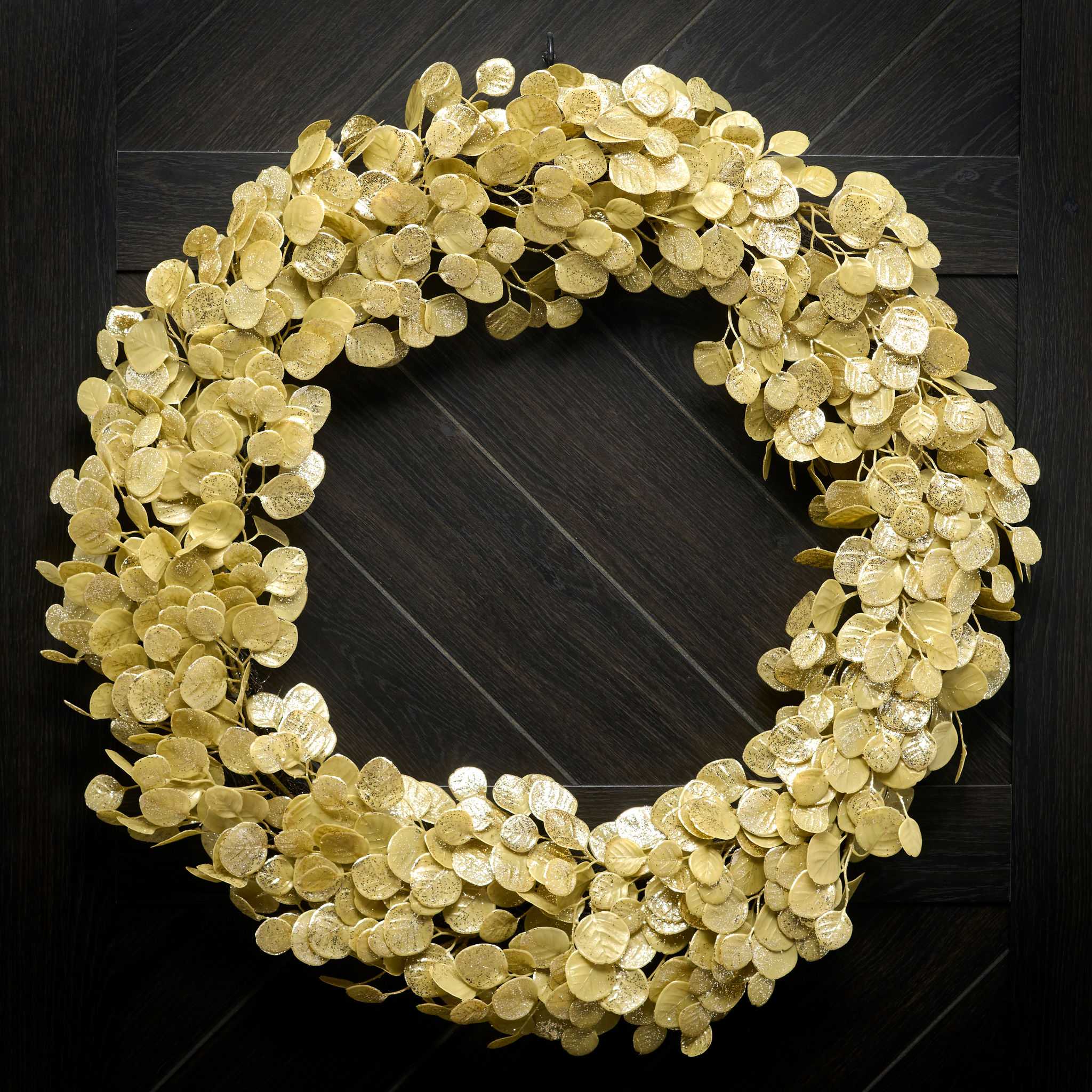Gold wreath on a dark wooden door