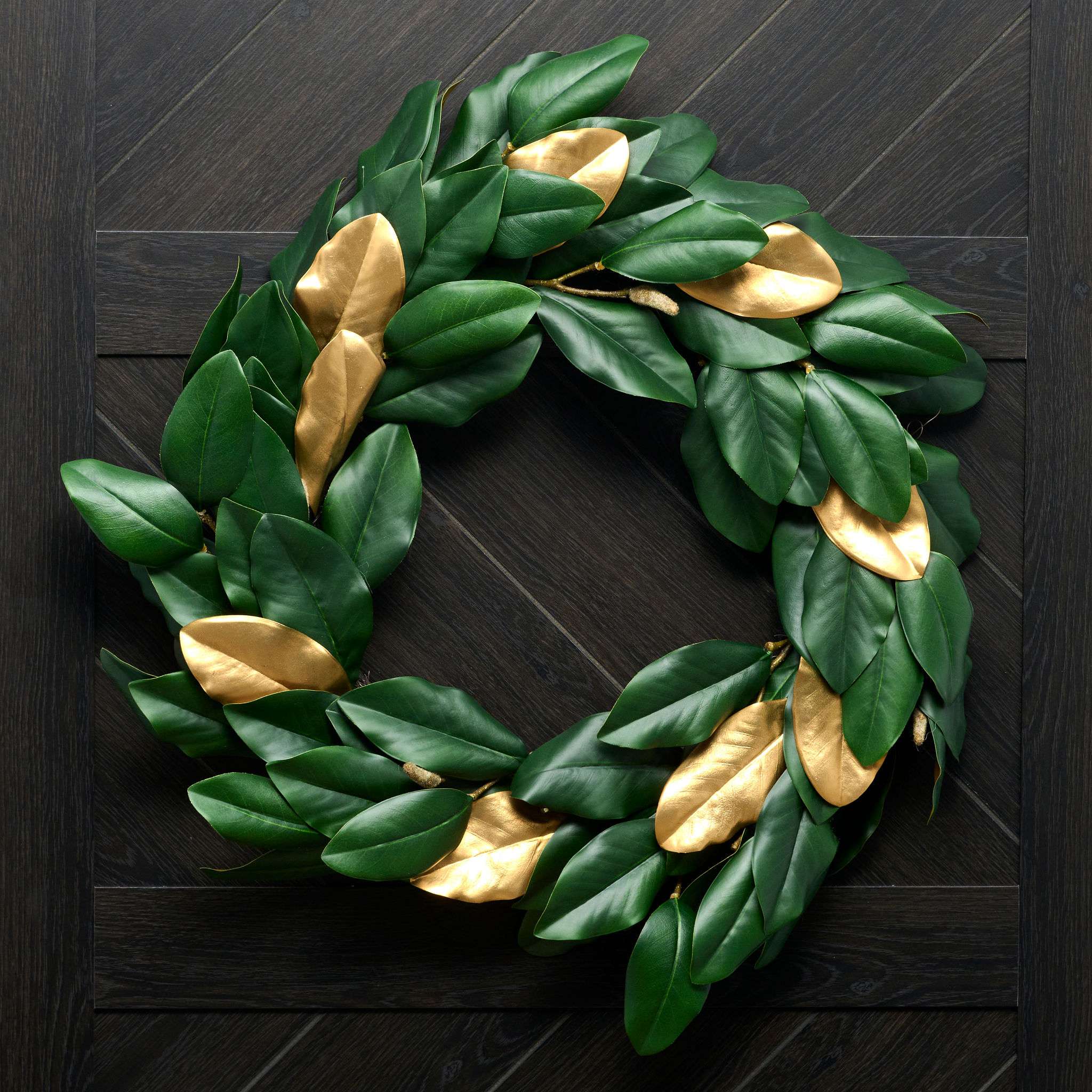 Green and gold leaf wreath on a dark wooden background