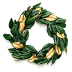 Wreath with green and gold leaves on a white background