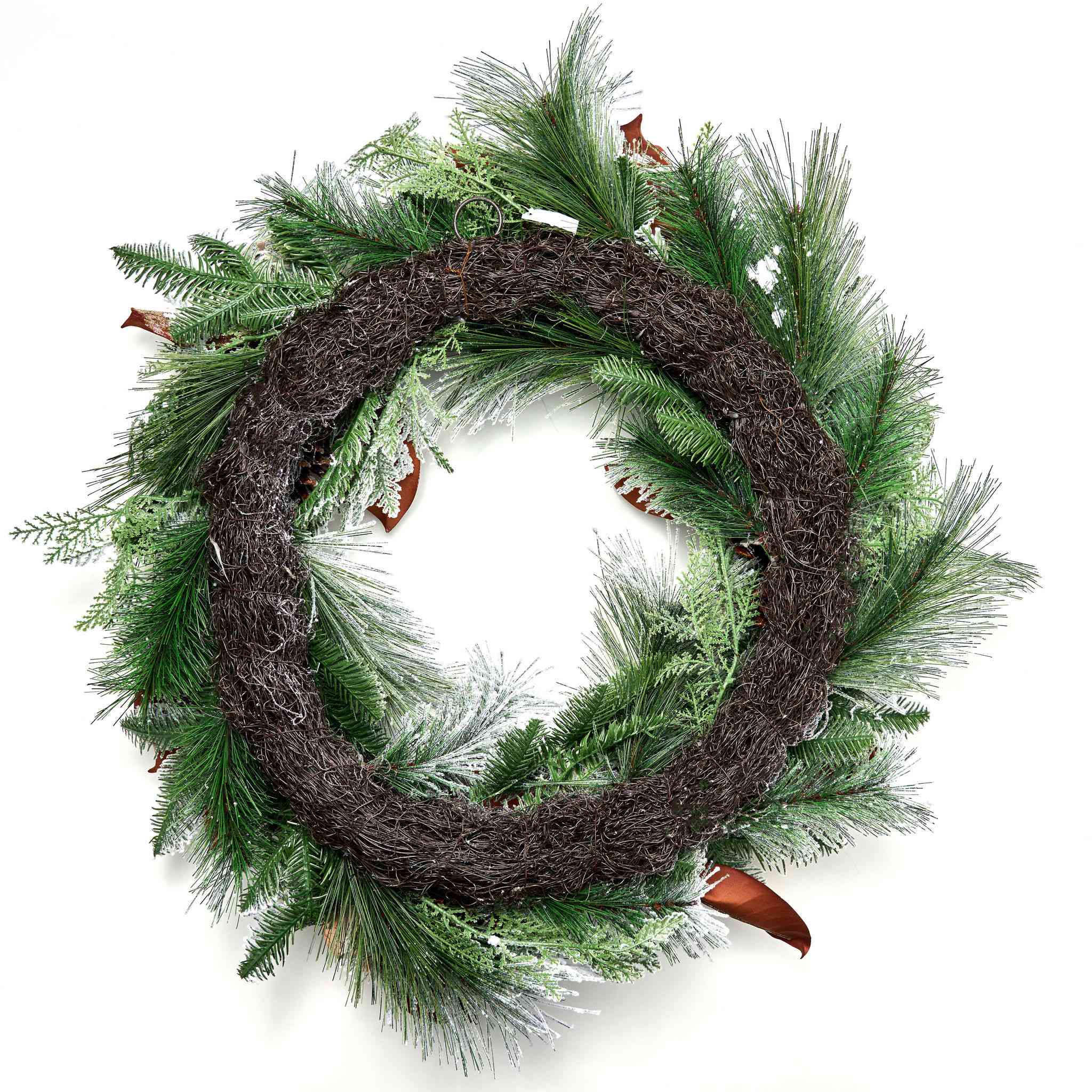 Decorative Christmas wreath with frosted pine branches, pinecones, and gold ornaments on a dark background.