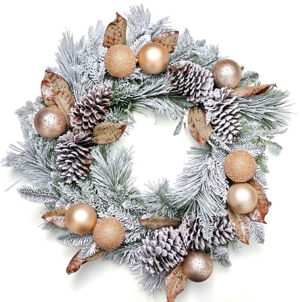 Decorative Christmas wreath with pine cones, gold balls, and other ornaments on a white background