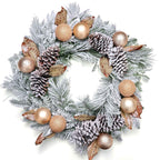 Decorative Christmas wreath with pine cones, gold balls, and other ornaments on a white background